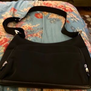 Limited handbag with multi pockets, black material, adjustable strap used 14x9